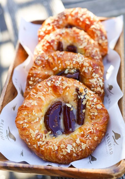 Poached Pear Fruit Danishes in a basket with Bellbird Bakery paper