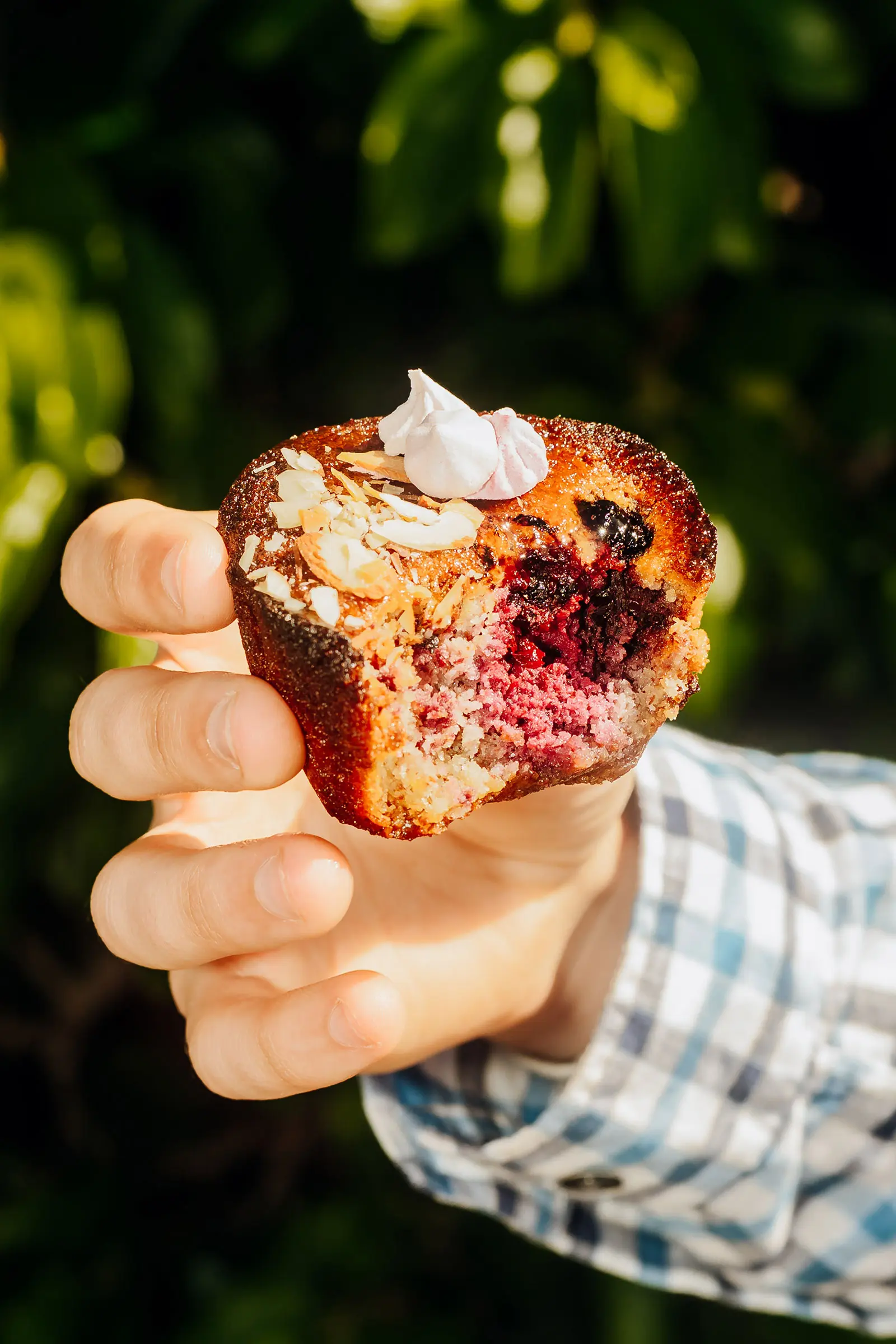 Brown butter and Berry Friand held in hand