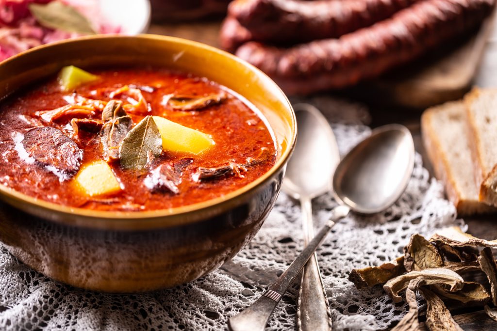 Cabbage soup - Kapustnica, a traditional Slovak, Czech and Polish festive dish in a bowl with spoons