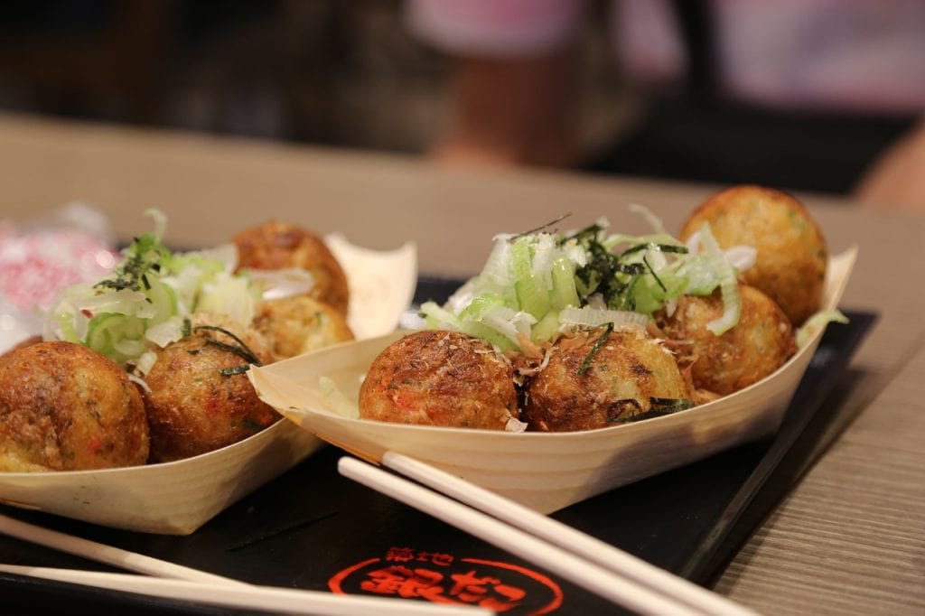 Takoyaki on boarts with chopsticks