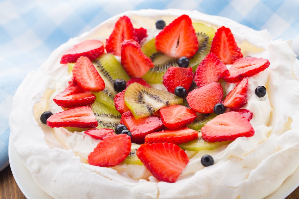 Pavlova cake with strawberry, kiwifruit and blueberries