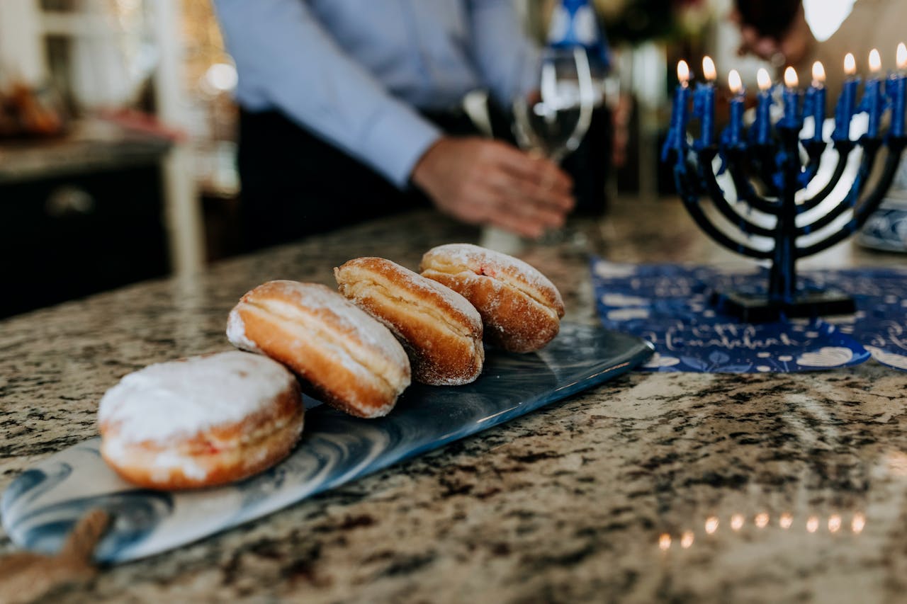 Sufganiyot on a table with Hanukkia