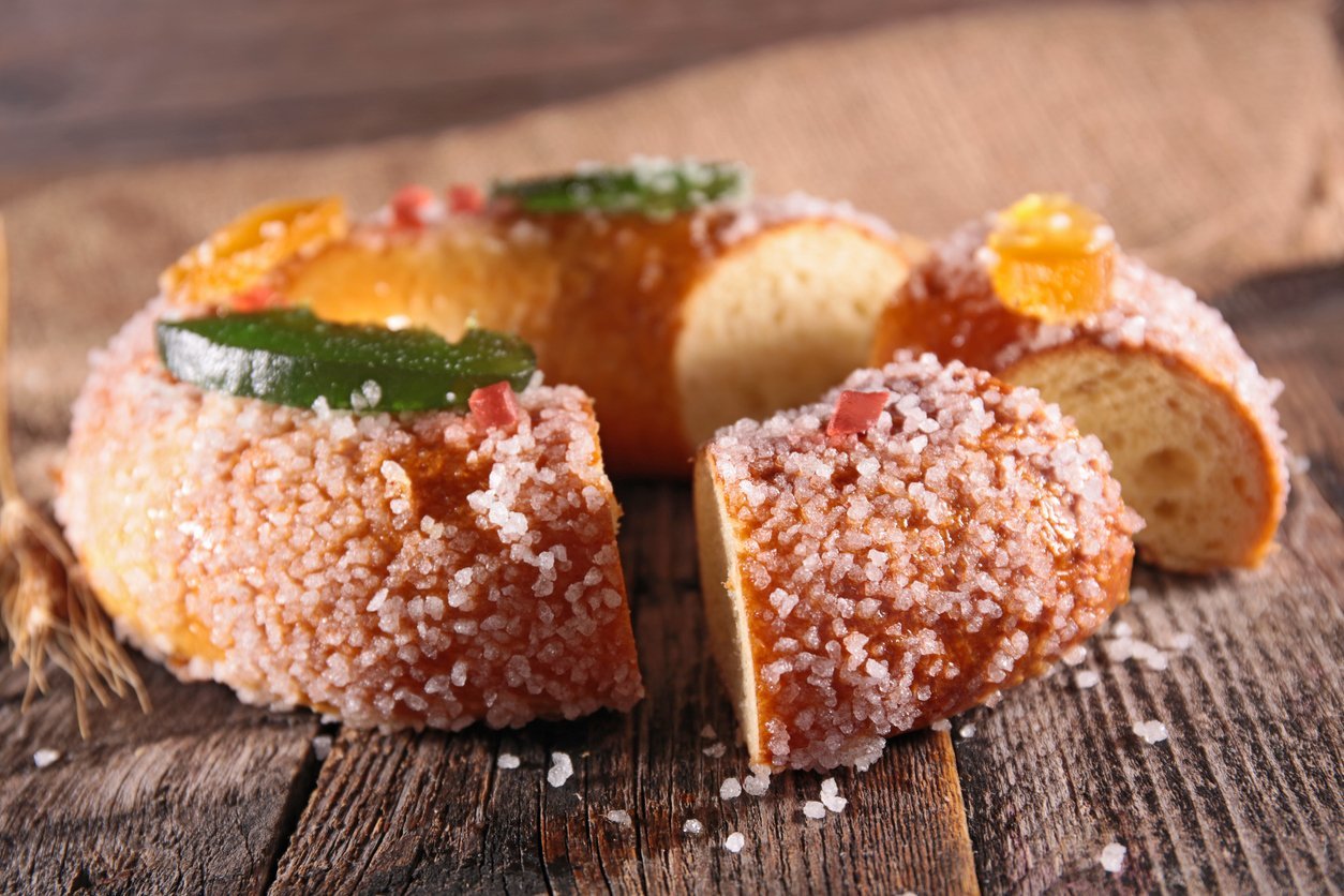 Couronne des rois briochée Galette des rois brioche with candied fruit on a wooden table