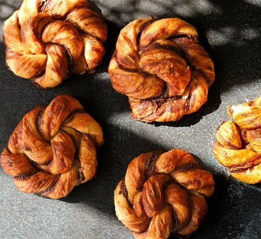 Cinnamon knots on grey background with ray of sun