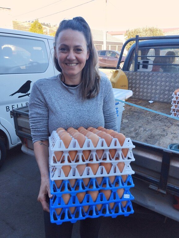 Gretha from Nutritional Farm NZ delivering trays of eggs to Bellbird Bakery in Woolson, Christchurch