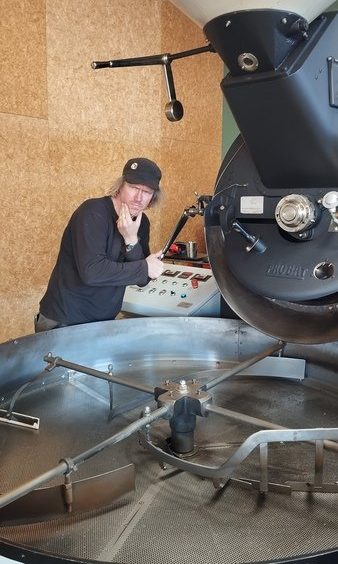 Jesse from Prima Roastery fake-operating the roasting machine