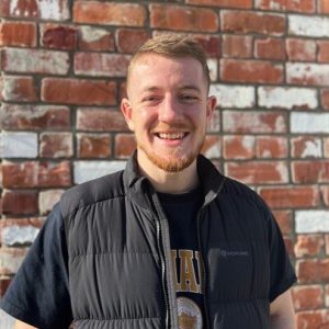 Niall in front of brick wall, The Tannery Christchurch
