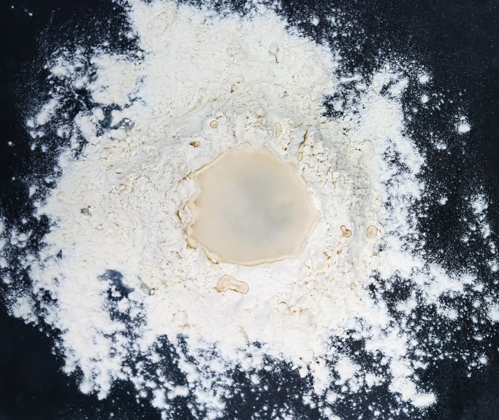 Flour and water on black background