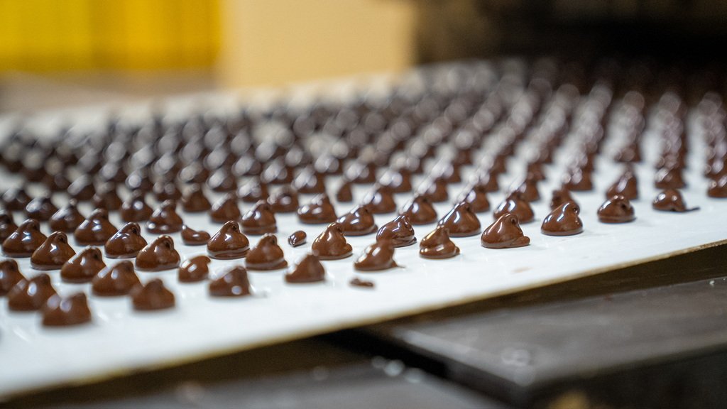Weave Cacao chocolate drops on production line in PNG