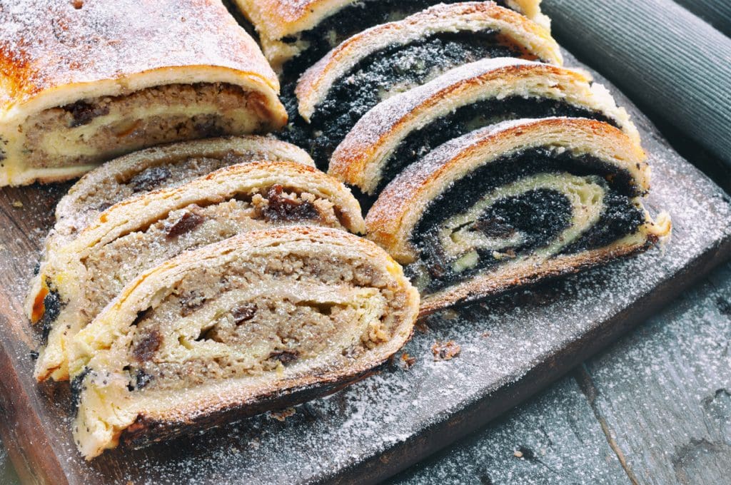 Bejgli - Hungarian poppy seed roll and walnut roll on wooden table