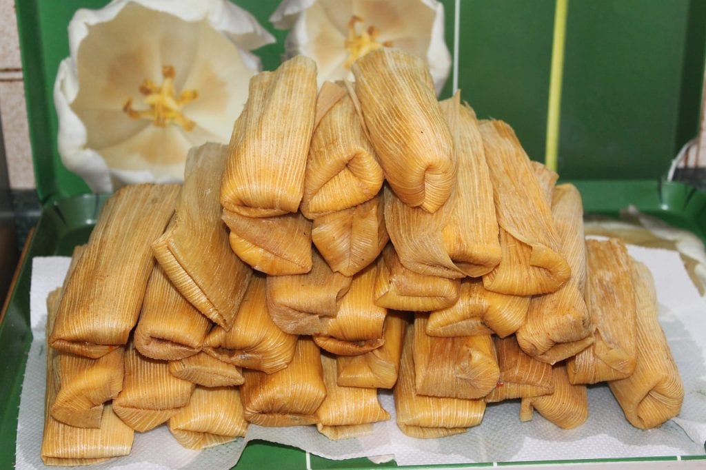 Stack of tamales on a green background