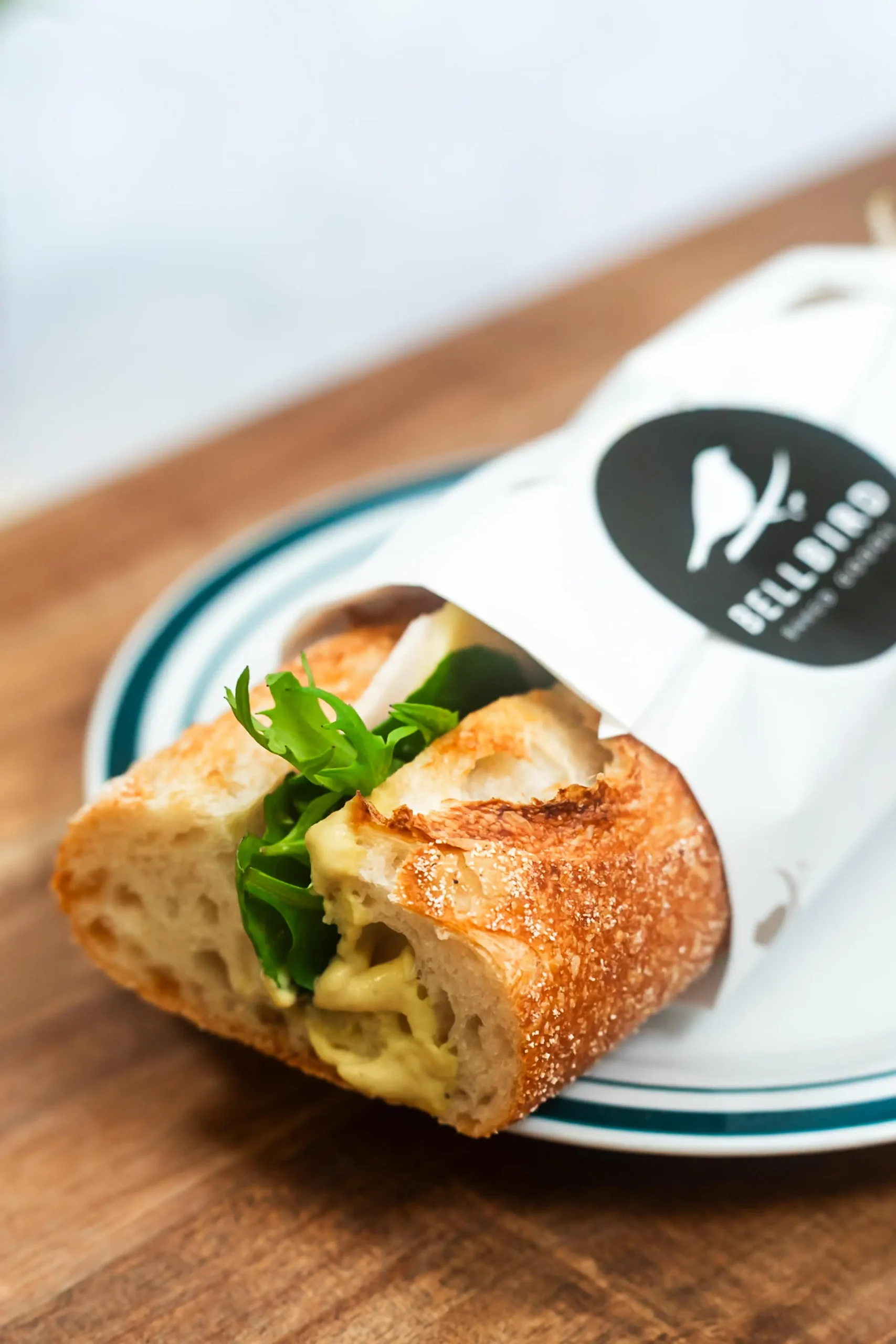 Ham & Cheese Baguette in Bellbird Bakery Wrapper on Board