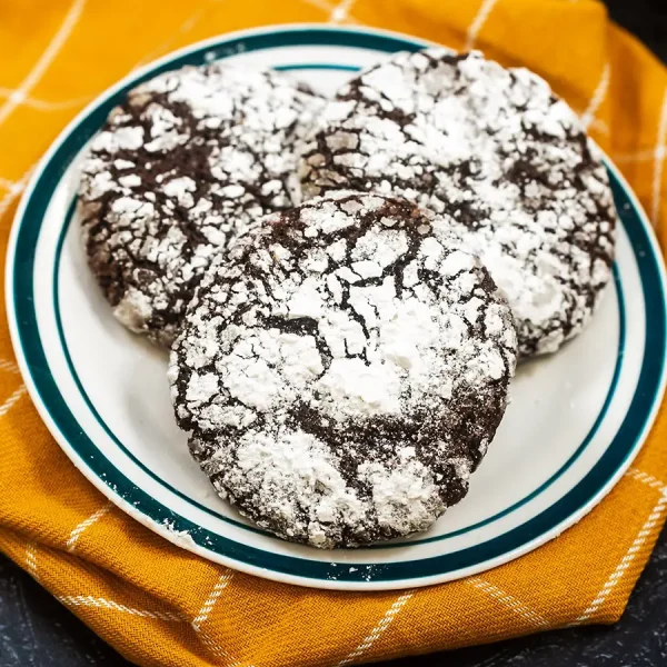 Chocolate Crinkle Cookie on plate and yellow kitchen towel