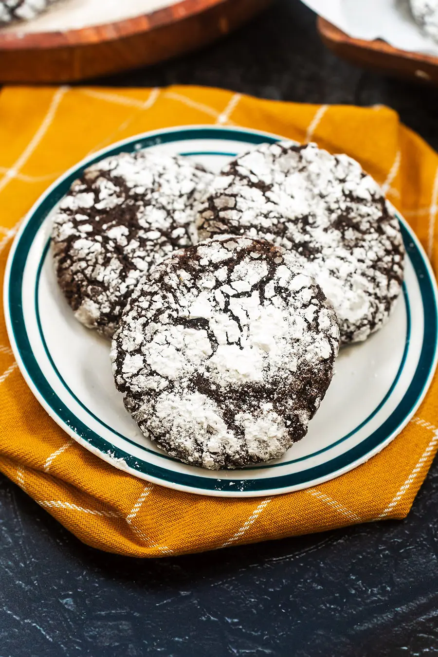 Chocolate Crinkle Cookie on plate and yellow kitchen towel