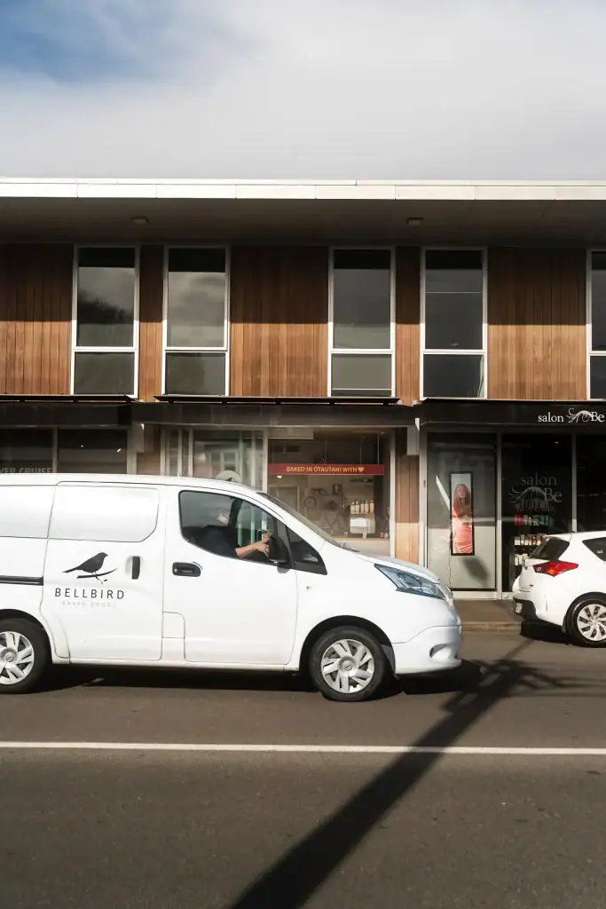 Bellbird Bakery Merivale store with Bellbird Delivery Van driving past