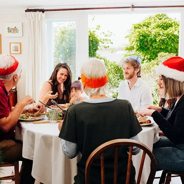 Family at christmas table enjoying baked goods
