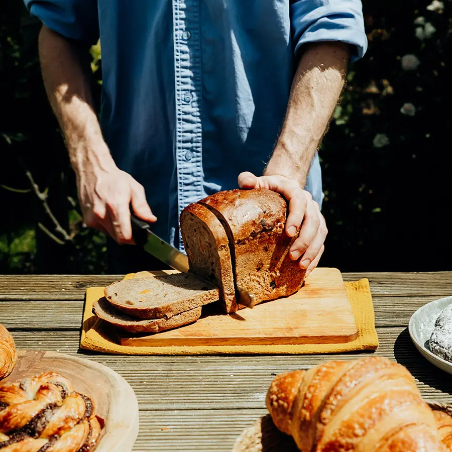 Fruit Loaf being chopped on board