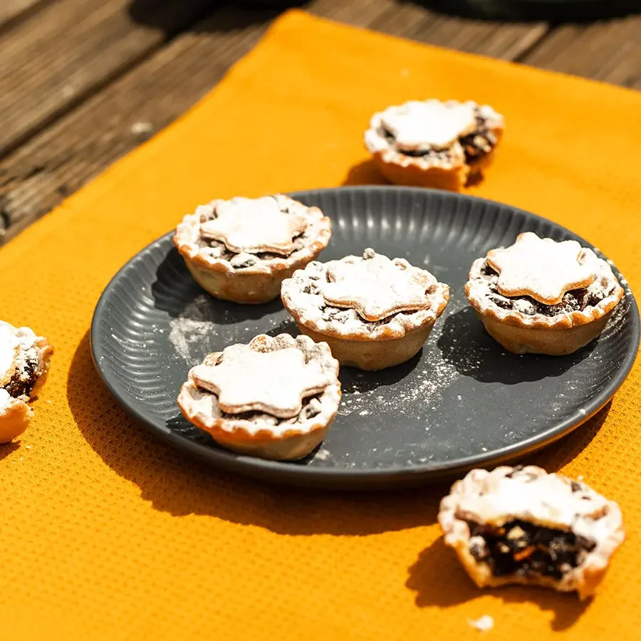 Fruit Mince Tarts from bellbird Bakery on green plate and yellow cloth,