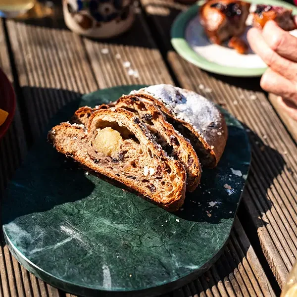 Fruit Stollen Sliced open on green board on christmas table