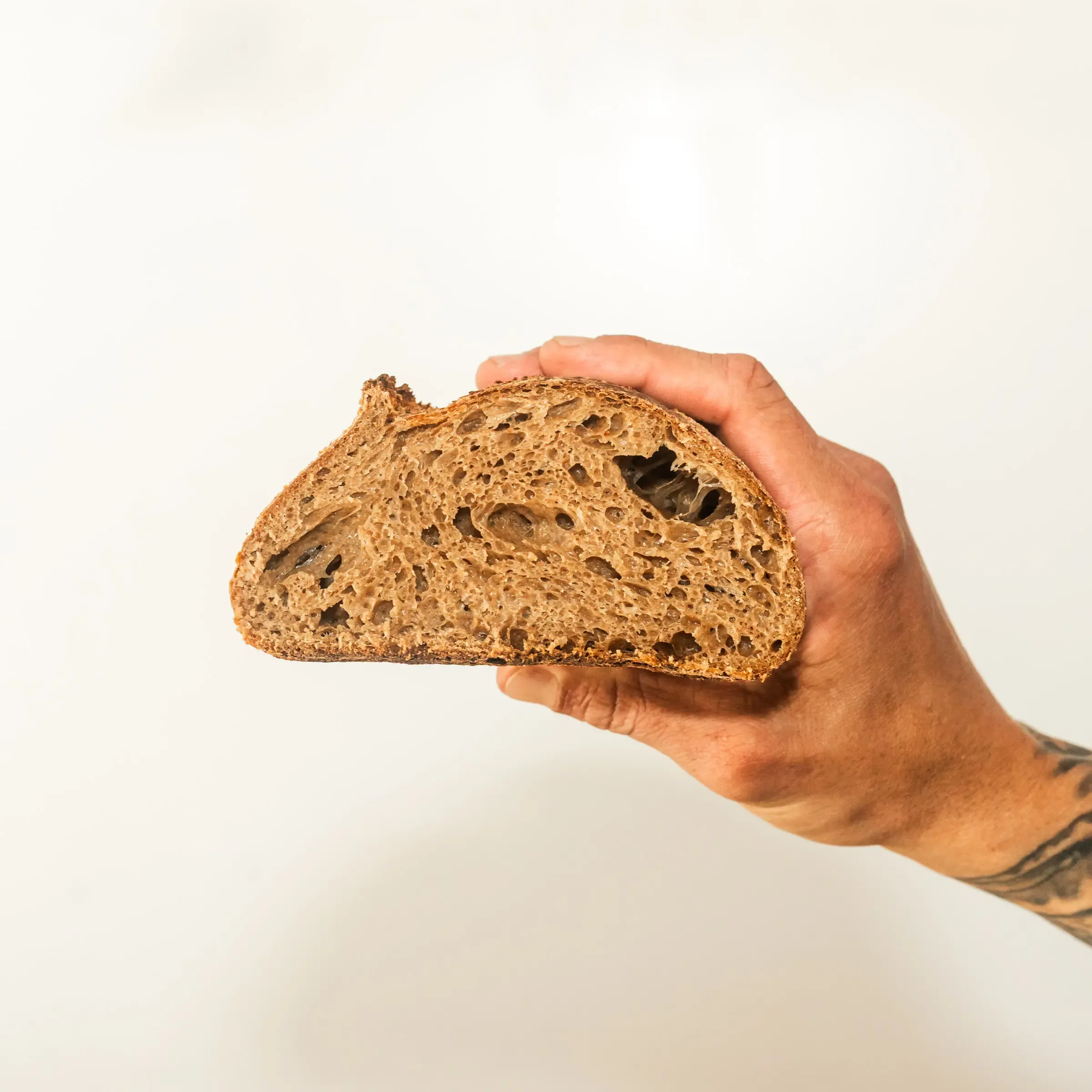 Organic Wholewheat Sourdough sliced held in hand