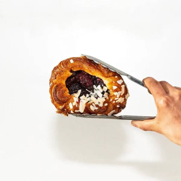 Boysenberry Danish Held in Tongs