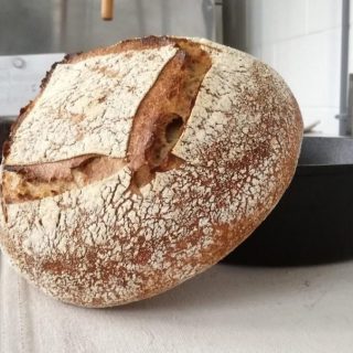 Sourdough loaf leaning on a Dutch oven during a Bellbird Baked Goods bread making workshop